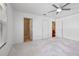 Spacious bedroom with neutral carpeting and ceiling fan at 17478 Se 77Th Sycamore Ave, The Villages, FL 32162