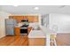 Galley kitchen with stainless steel appliances and wood cabinets at 17478 Se 77Th Sycamore Ave, The Villages, FL 32162