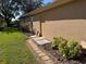 House exterior showcasing a walkway and side yard with mature plants at 21630 King Henry Ave, Leesburg, FL 34748