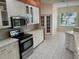 Kitchen with white cabinets, stainless steel appliances, and access to breakfast nook at 21630 King Henry Ave, Leesburg, FL 34748