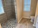 Walk-in shower with pebble floor and modern finishes at 21630 King Henry Ave, Leesburg, FL 34748