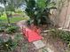 Peaceful Japanese garden with red bridge, stone path, and lush foliage at 21630 King Henry Ave, Leesburg, FL 34748