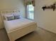 Bright bedroom with a queen-size bed and access to a private patio at 21630 King Henry Ave, Leesburg, FL 34748