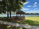 Lakeside gazebo with a view of a tranquil lake and lush greenery at 21630 King Henry Ave, Leesburg, FL 34748