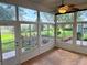 Bright sunroom with tile floor, ceiling fan, and scenic views at 21630 King Henry Ave, Leesburg, FL 34748