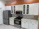 Modern kitchen with white cabinets, stainless steel appliances and a breakfast bar at 21630 King Henry Ave, Leesburg, FL 34748