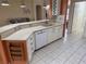 Kitchen with white cabinets, stainless steel dishwasher, and a breakfast bar at 21630 King Henry Ave, Leesburg, FL 34748