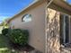 Well-maintained house exterior with landscaping and a sliding glass door at 21630 King Henry Ave, Leesburg, FL 34748