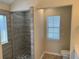 Walk-in shower with pebble floor and modern finishes at 21630 King Henry Ave, Leesburg, FL 34748