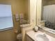 Bathroom with single sink vanity and shower/tub combo at 21630 King Henry Ave, Leesburg, FL 34748