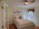 Bedroom with a white bed frame and bird artwork at 21630 King Henry Ave, Leesburg, FL 34748