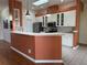 Modern kitchen with white cabinets, stainless steel appliances, and a breakfast bar at 21630 King Henry Ave, Leesburg, FL 34748