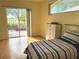 Bedroom with sliding glass doors leading to the patio at 21630 King Henry Ave, Leesburg, FL 34748