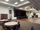 Large community hall with stage, dance floor, and ample seating at 21630 King Henry Ave, Leesburg, FL 34748