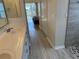 Double vanity bathroom with access to the bedroom and shower at 21630 King Henry Ave, Leesburg, FL 34748