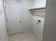 Simple laundry room with washer, dryer, and hanging rack at 21630 King Henry Ave, Leesburg, FL 34748