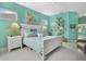 Serene bedroom with white bed frame and aqua walls at 2440 Pawtucket Pass, Mount Dora, FL 32757