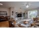 Living room with hardwood floors, a large TV, and comfortable seating at 3332 Flagship Ave, Tavares, FL 32778