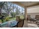 Relaxing screened patio with seating area and view of backyard at 3332 Flagship Ave, Tavares, FL 32778