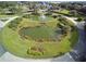 Community entrance with circular pond and fountain at 3332 Flagship Ave, Tavares, FL 32778
