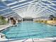 Community pool with a screened enclosure at 3332 Flagship Ave, Tavares, FL 32778