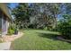 Peaceful backyard with mature trees and lush landscaping at 3332 Flagship Ave, Tavares, FL 32778
