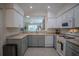 Open kitchen with white cabinets, granite countertops, and breakfast bar at 3332 Flagship Ave, Tavares, FL 32778