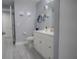 Clean bathroom with white vanity, grey floors, and a large mirror at 3406 Soho St # 102, Orlando, FL 32835