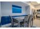 Cozy dining area with gray table and chairs, blue accent wall at 3406 Soho St # 102, Orlando, FL 32835