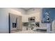 Modern kitchen with stainless steel appliances and white cabinets at 3406 Soho St # 102, Orlando, FL 32835
