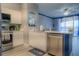 Modern kitchen with island, stainless steel appliances, and white cabinets at 3406 Soho St # 102, Orlando, FL 32835