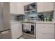 Modern kitchen with stainless steel appliances and white cabinets at 3406 Soho St # 102, Orlando, FL 32835