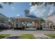 Gated community entrance with clock tower and landscaping at 3406 Soho St # 102, Orlando, FL 32835