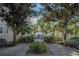 Seating area with tranquil lake view through trees at 3406 Soho St # 102, Orlando, FL 32835