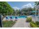 Inviting pool area with lounge chairs and landscaping at 3406 Soho St # 102, Orlando, FL 32835
