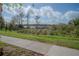 Scenic view of a lake with a pier and lush greenery at 3406 Soho St # 102, Orlando, FL 32835