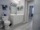 Modern bathroom with double vanity and gray floors at 3406 Soho St # 102, Orlando, FL 32835