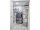 Laundry room with washer, dryer, and storage shelves at 3406 Soho St # 102, Orlando, FL 32835