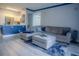 Open concept living room and kitchen with grey sectional sofa and blue accents at 3406 Soho St # 102, Orlando, FL 32835