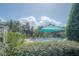 Refreshing pool with umbrellas and lush greenery at 3406 Soho St # 102, Orlando, FL 32835