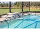 Relaxing pool with waterfall feature and screened enclosure at 38805 Ranch Gate Blvd, Umatilla, FL 32784