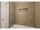 Clean bathroom with a shower/tub combo and wood-look tile at 38805 Ranch Gate Blvd, Umatilla, FL 32784