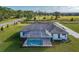 Aerial view of house with pool and screened enclosure at 38805 Ranch Gate Blvd, Umatilla, FL 32784