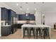 Modern kitchen with dark blue cabinetry, quartz countertops, and an island at 38805 Ranch Gate Blvd, Umatilla, FL 32784