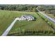 Aerial view of a single-story house with a large yard and pool at 38805 Ranch Gate Blvd, Umatilla, FL 32784