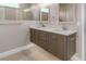 Double vanity bathroom with modern fixtures and grey cabinets at 38805 Ranch Gate Blvd, Umatilla, FL 32784