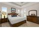 Main bedroom with wooden furniture and access to backyard at 38805 Ranch Gate Blvd, Umatilla, FL 32784