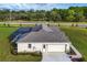 Aerial view showcasing a home's rear, highlighting the pool and garage at 38805 Ranch Gate Blvd, Umatilla, FL 32784