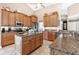 Kitchen with granite countertops, wood cabinets, and a large island at 39509 Harbor Hills Blvd, Lady Lake, FL 32159