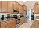 Kitchen features stainless steel appliances and ample wood cabinets at 39509 Harbor Hills Blvd, Lady Lake, FL 32159